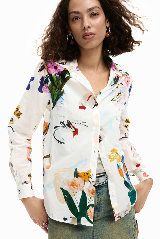 Woman wearing a colorful floral shirt with a white background