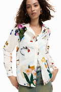 Woman wearing a colorful floral shirt with a white background