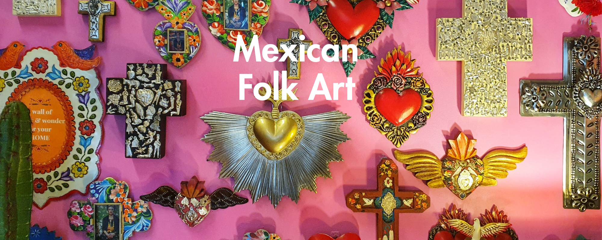 A vibrant display of Mexican folk art objects, including ornate crosses, Sacred Heart of Jesus medals, and decorative frames, arranged against a bright pink background with the text 'Mexican Folk Art' overlaid in the center.