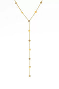 Gold necklace with small beads on a white background