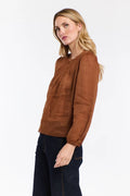 Woman wearing a brown blouse with long sleeves on a white background