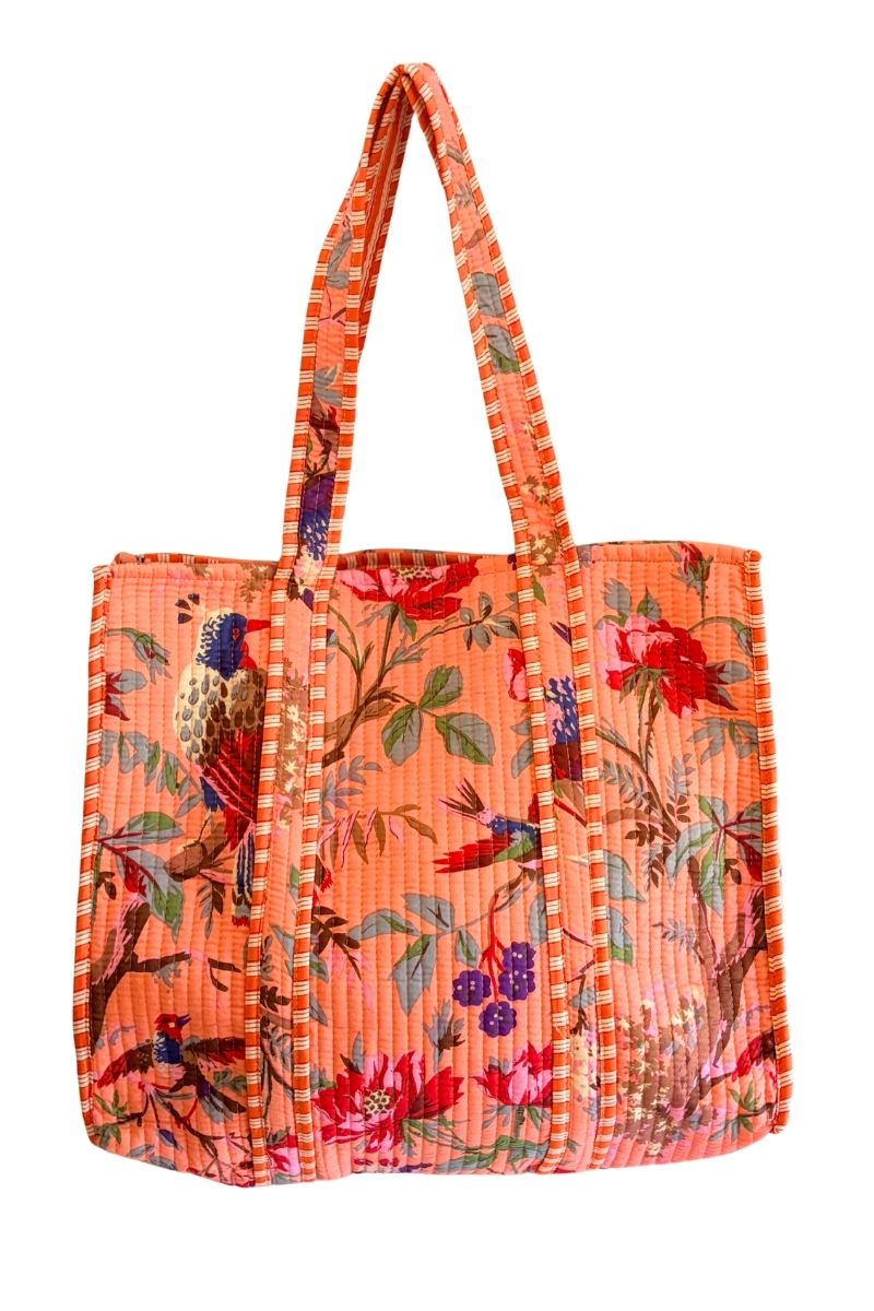 A structured tote bag with a vibrant orange background and a detailed multicolor print featuring birds, flowers, and foliage, complete with two shoulder straps.