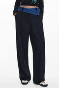 Black pants with blue denim waistband on a white background
