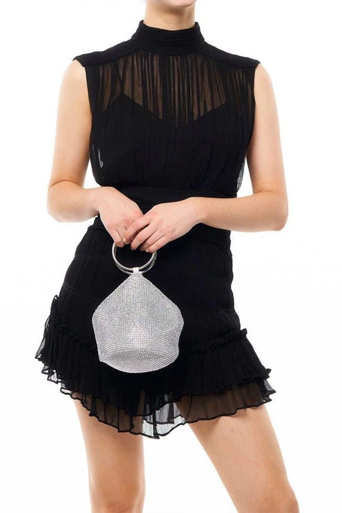 silver handbag held by a person on a white background