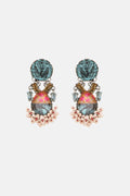 Pair of colorful earrings with floral elements on a white background
