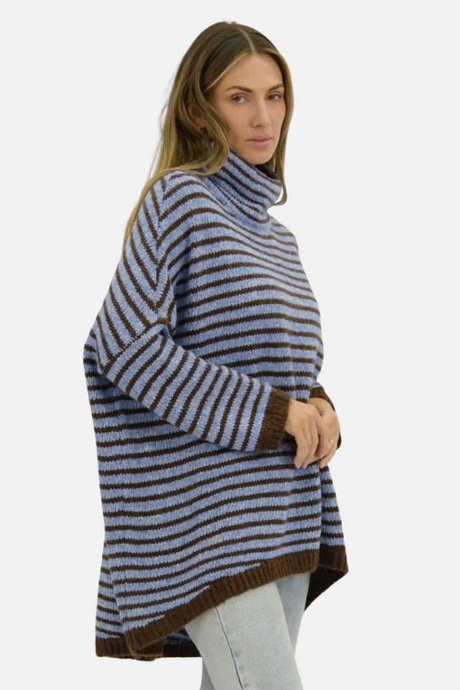 Woman wearing a striped turtleneck sweater on a white background