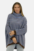 Woman wearing a blue and brown striped sweater on a white background