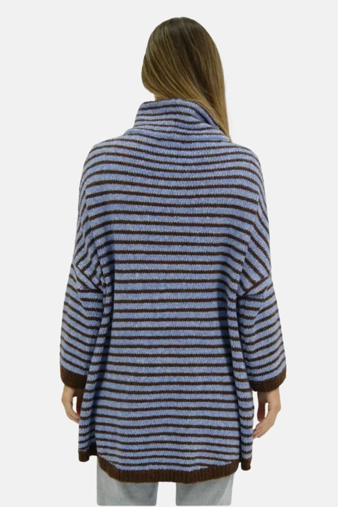 Woman wearing a blue and brown striped sweater on a white background