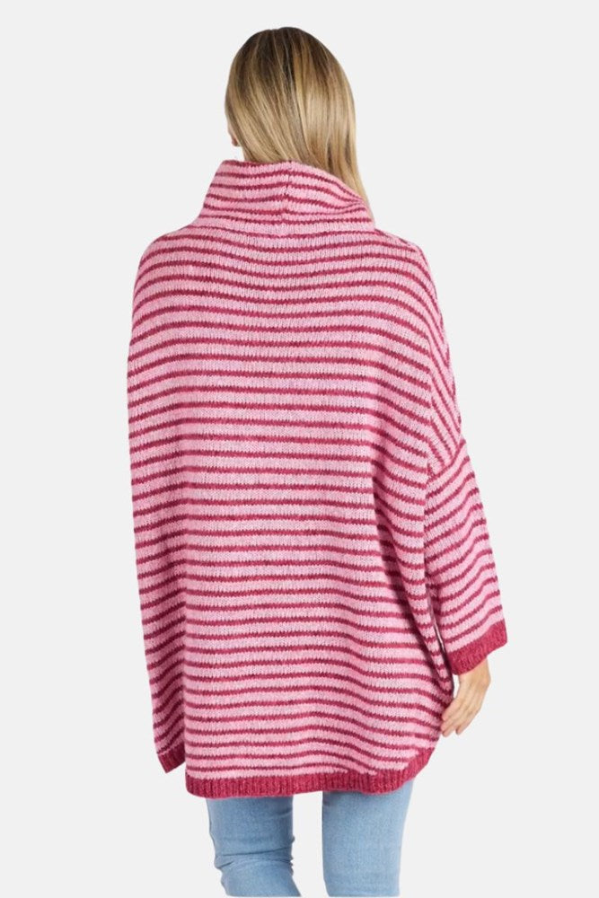 Person wearing a pink and white striped sweater on a light gray background