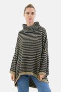 Woman wearing a striped poncho against a white background