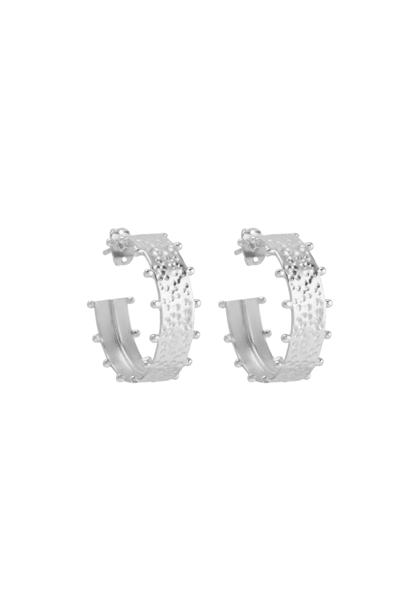Silver hoop earrings with perforated detail on a white background